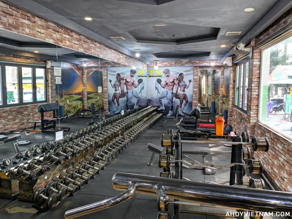 A rack of dumbbells and exercise benches inside CLB Fitness T&V in Ho Chi Minh City