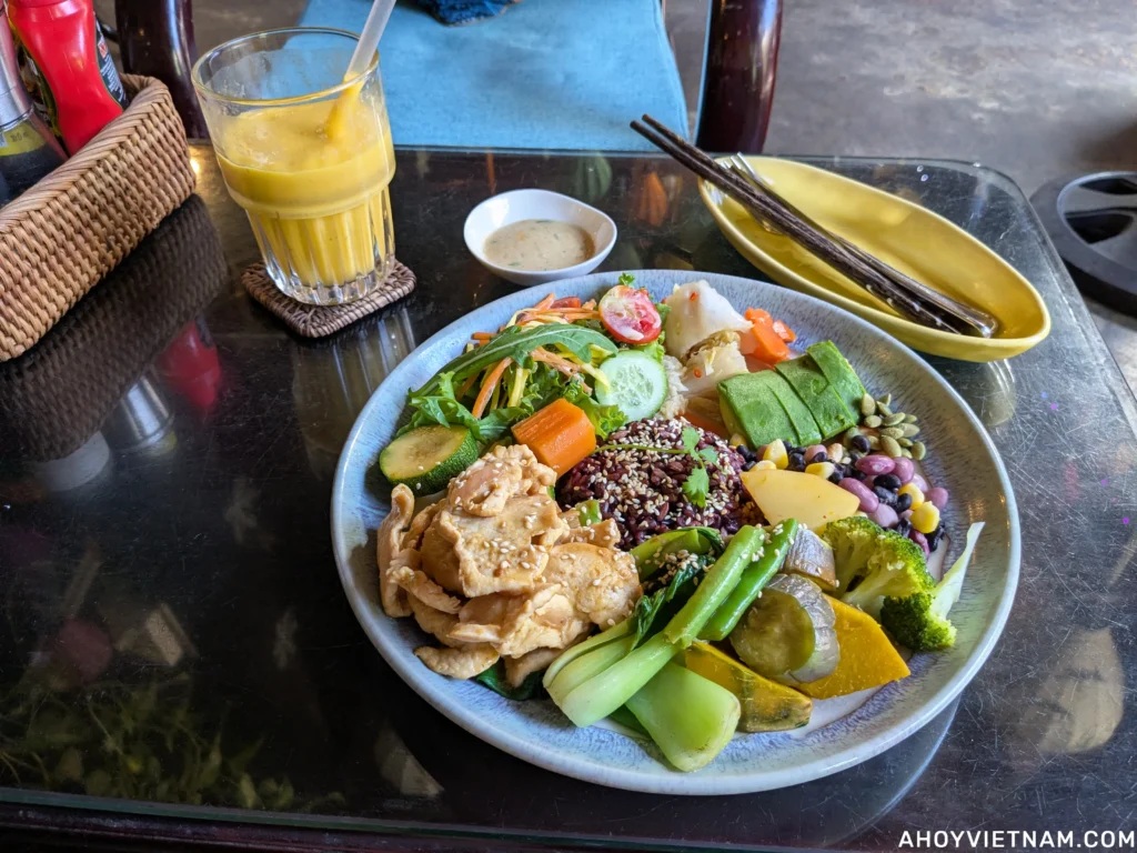 A mango smoothie and a chicken bowl with vegetables at Lanterns Cafe in Hoi An Old Town.