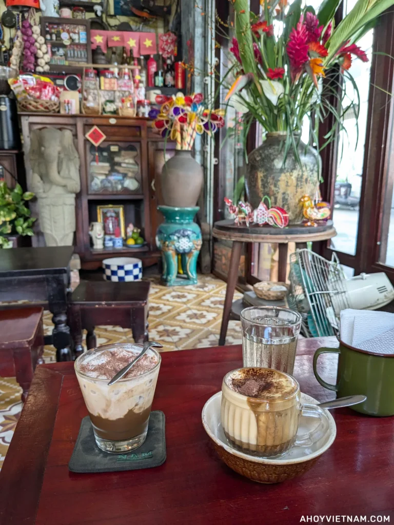 An iced peanut coffee on the left, and a hot egg coffee on the right at NAM House Cafe in Da Nang, Vietnam.