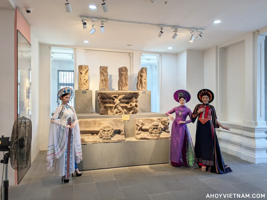 Vietnamese women wearing Ao Dais inside the Da Nang Museum of Cham Sculpture