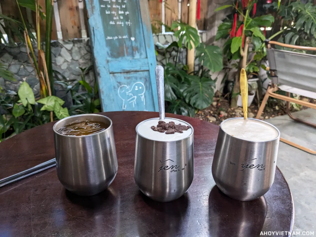 Water and coffee in three metal cups at Yen Coffee in Da Nang, Vietnam.