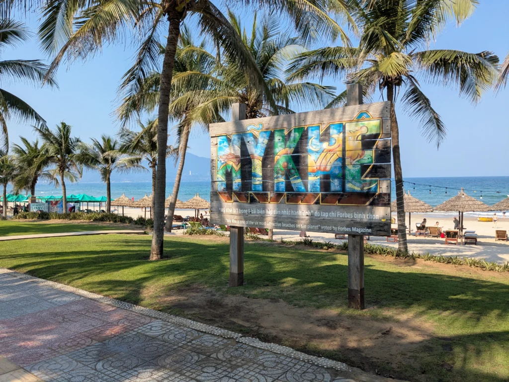 A colorful wooden "MY KHE" sign on My Khe Beach in Da Nang.