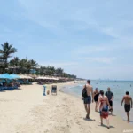 Tourists on An Bang Beach, looking north along the coast toward Da Nang.