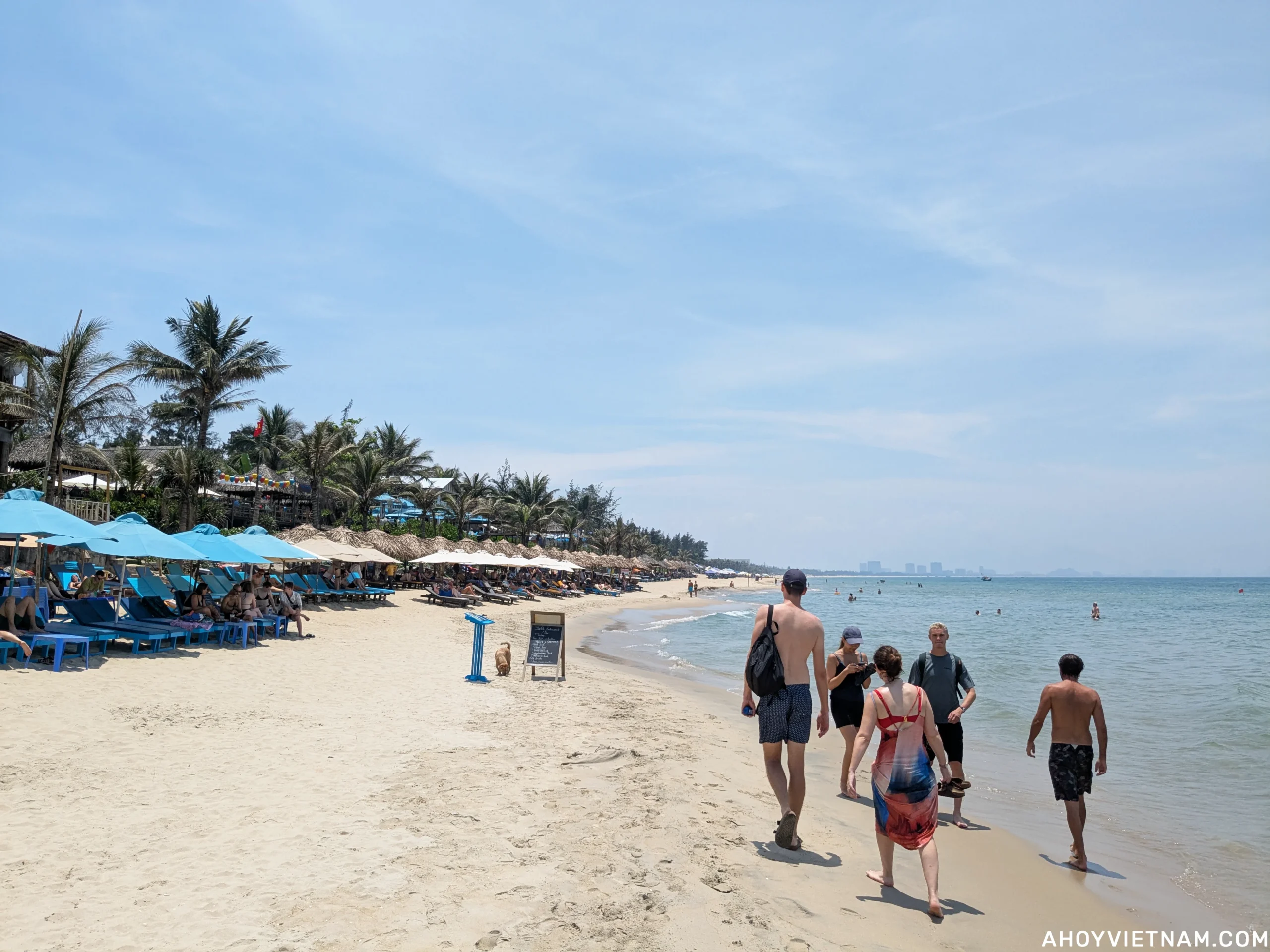 Tourists on An Bang Beach, looking north along the coast toward Da Nang.