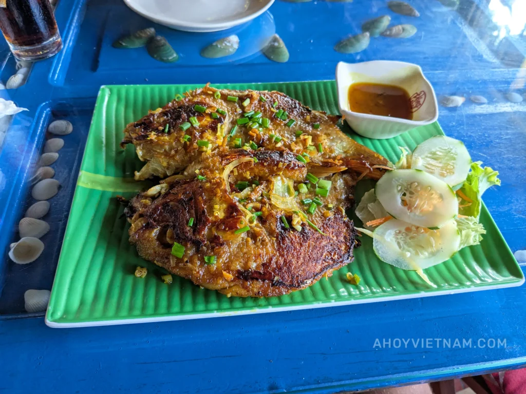 Eating grilled red tilapia at Mom's Restaurant in An Bang Beach in Hoi An, Vietnam.