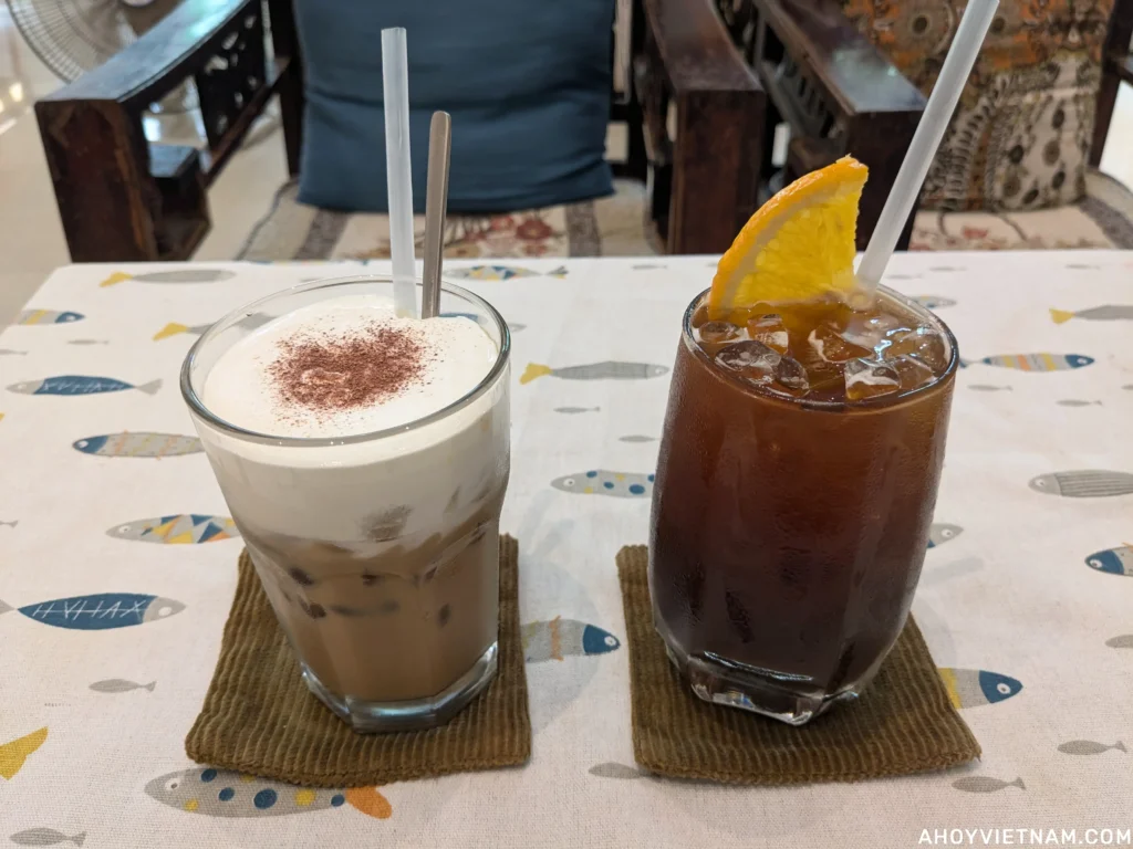An iced salted cream coffee and an iced Americano with an orange slice at a coffee shop in Da Nang.