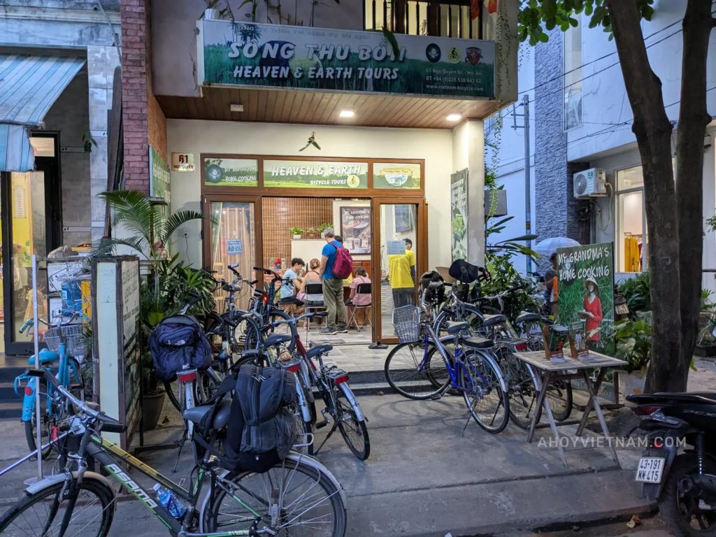 Outside Heaven & Earth Bicycle Tours in Hoi An, with guests inside and several bicycles out front.