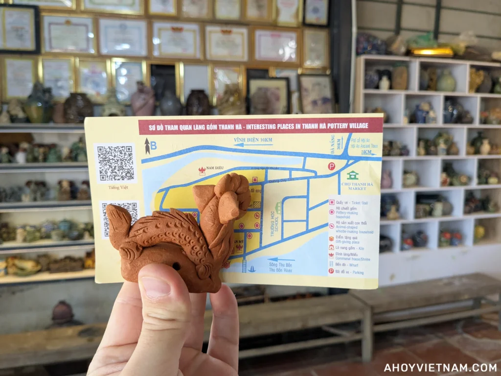 A small clay sculpture of a dragon and my entrance ticket to Thanh Ha Pottery Village in Hoi An