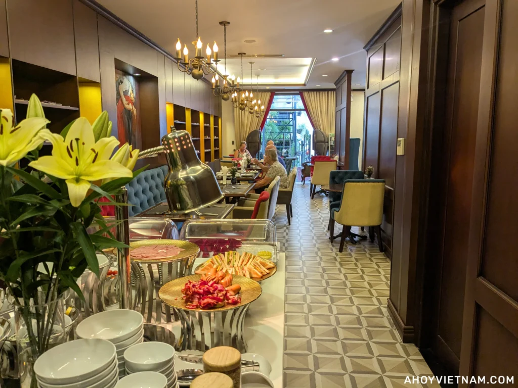 Guests eating breakfast inside the Scarlett Boutique Hotel Hue