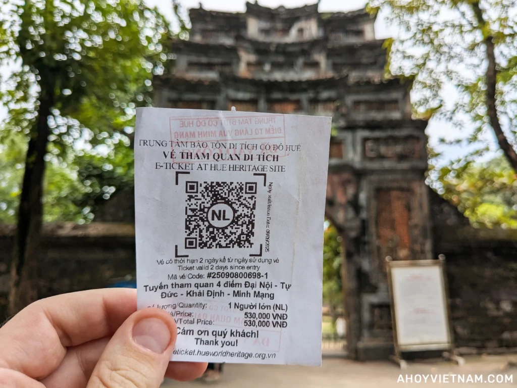 Holding up my four-site combo ticket outside Tu Duc tomb in Hue, Vietnam.