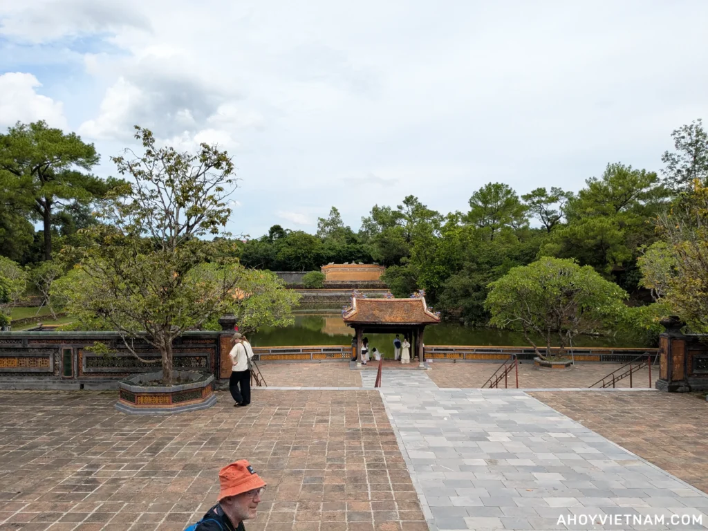 Tourists walking around Luu Khiem Lake at the Mausoleum of Emperor Tu Duc in Hue, Vietnam