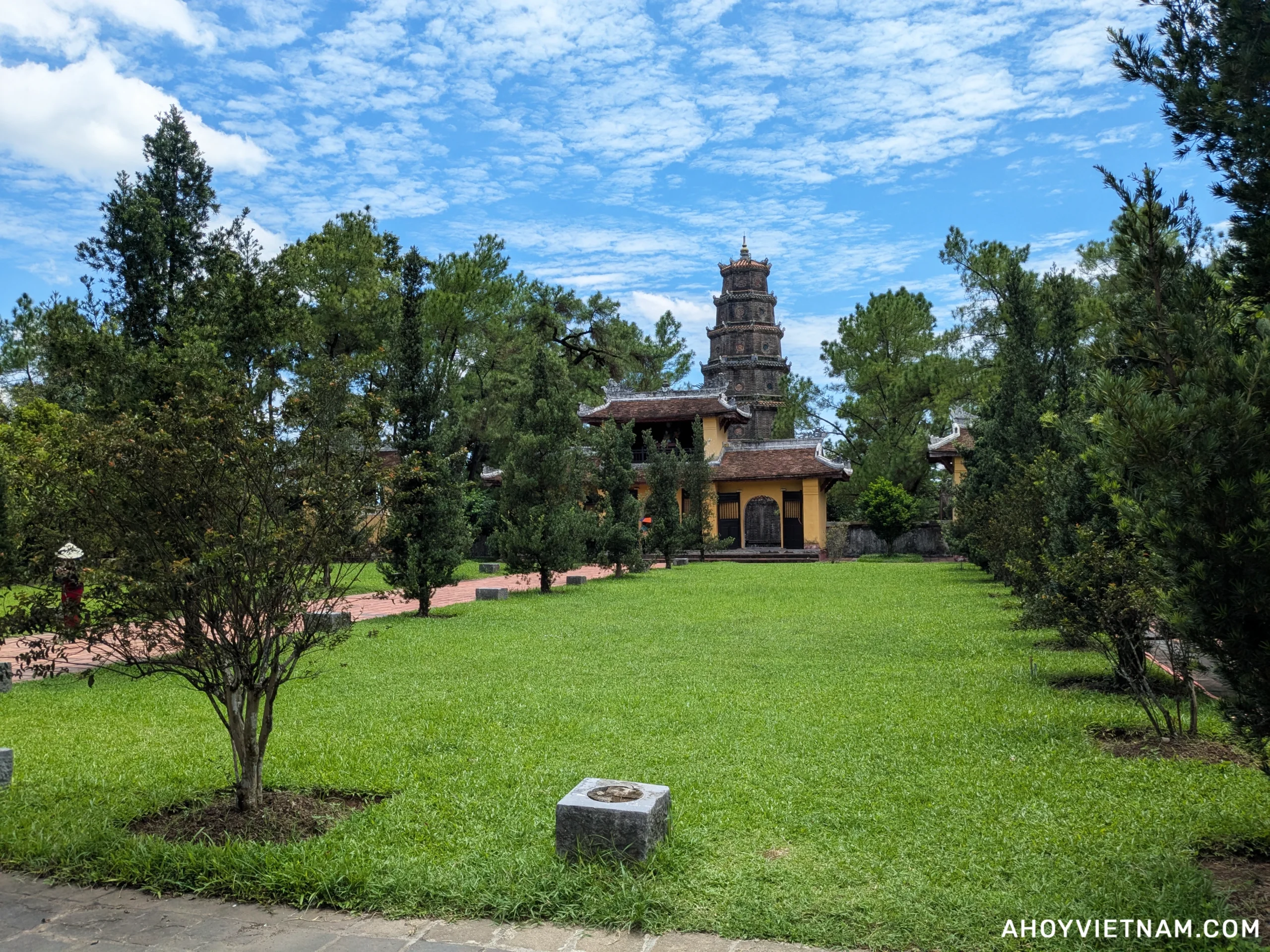Green grass and blue skies on the grounds of Thien Mu Pagoda in Hue, Vietnam
