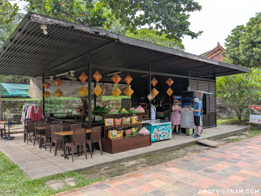 A vendor selling souvenirs and drinks inside Tu Duc's tomb in Hue, Vietnam