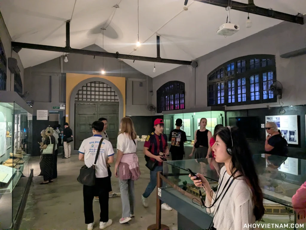 Visitors inside an exhibit at Hoa Lo Prison in Hanoi, Vietnam