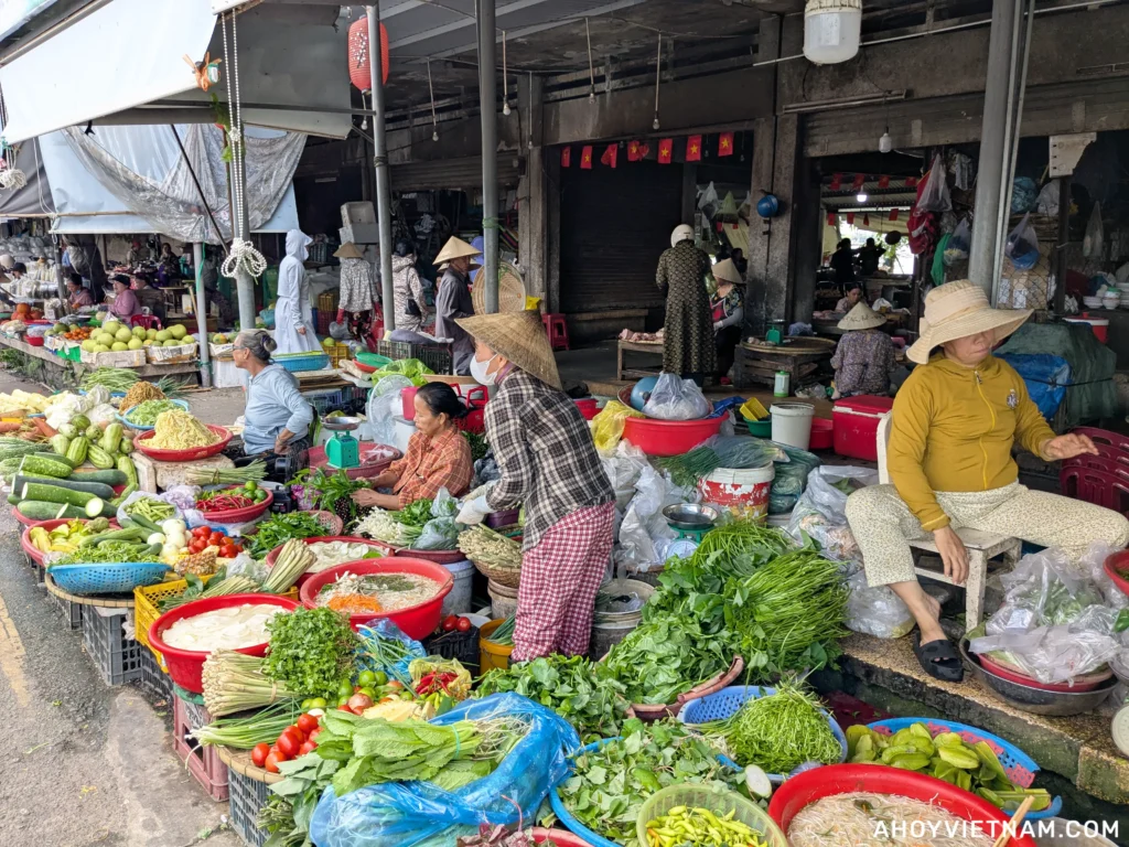 Local vendors selling vegetables outside of Dong Ba Market in Hue, Vietnam