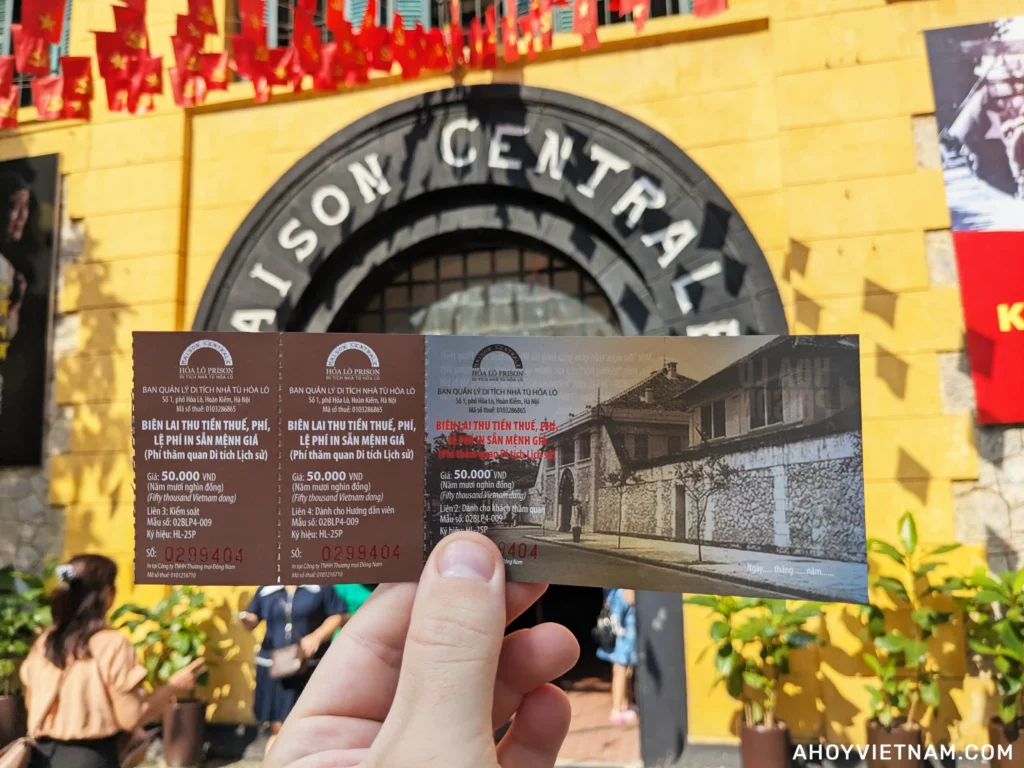 Holding up my entrance ticket outside Hoa Lo Prison in Hanoi, Vietnam