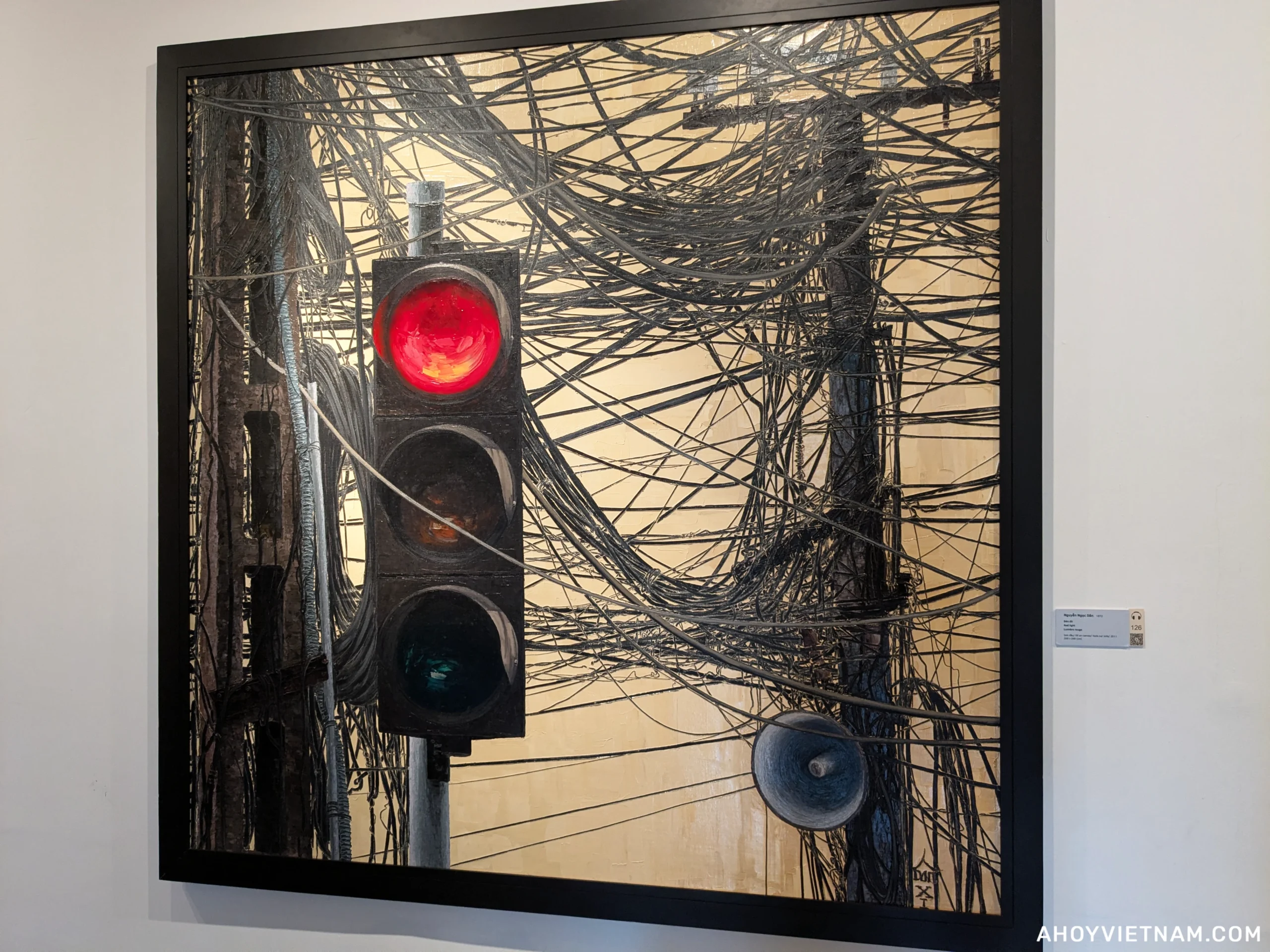 A painting by Vietnamese artist Nguyen Ngoc Dan showing a red stop light tangled with numerous electrical wires