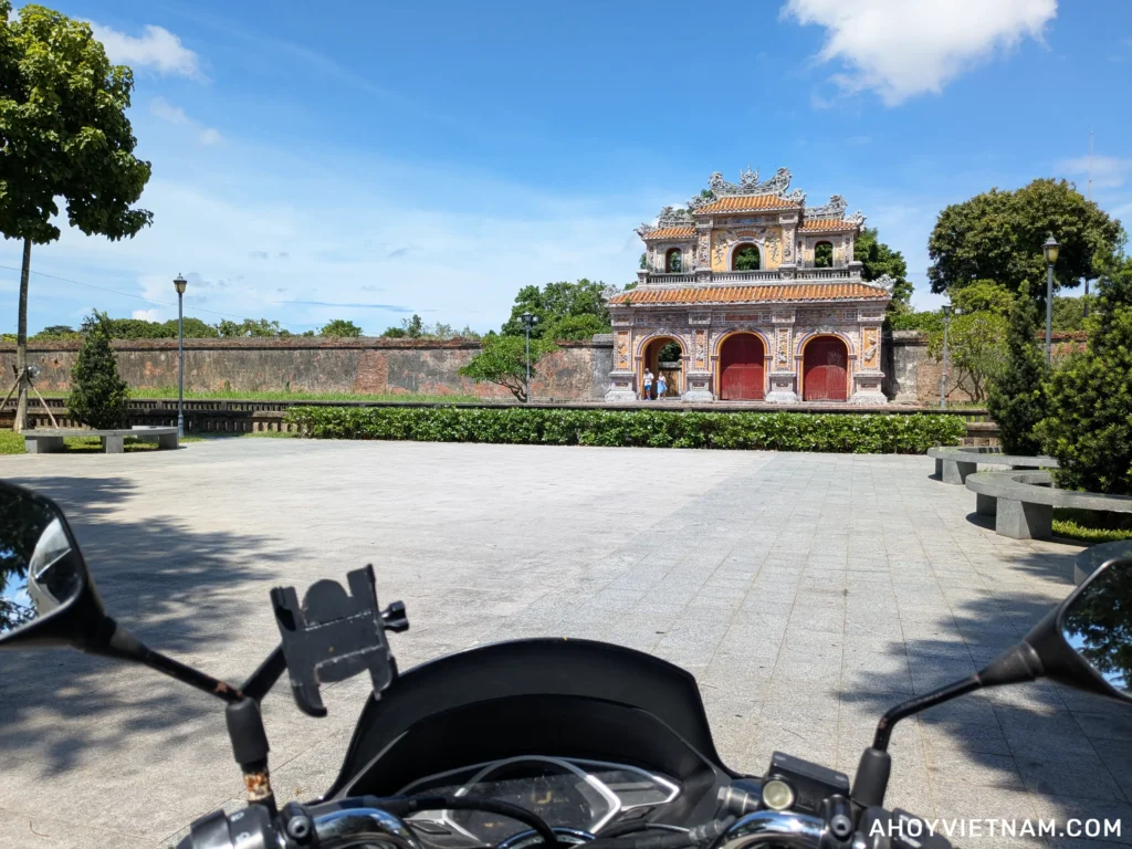 Sitting on my Honda PCX scooter outside the walls of the Hue Citadel