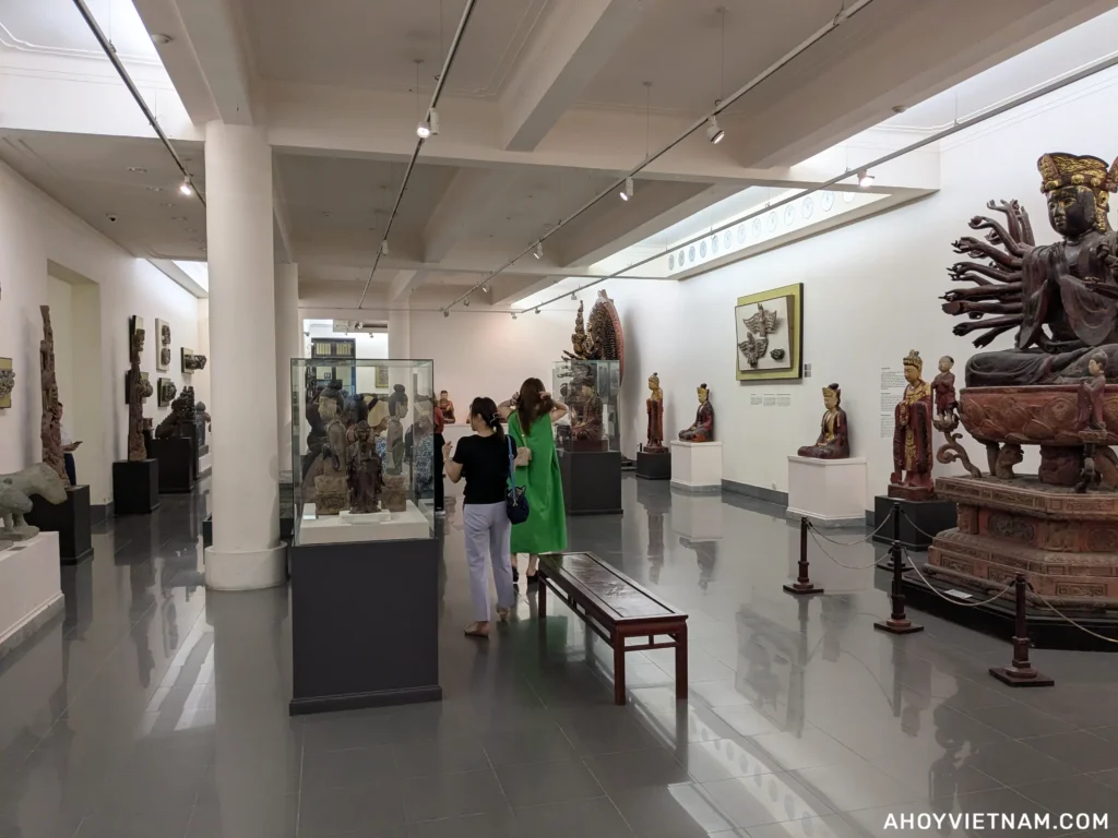 Visitors inside an exhibit with several statues and sculptures at the Vietnam National Fine Arts Museum in Hanoi