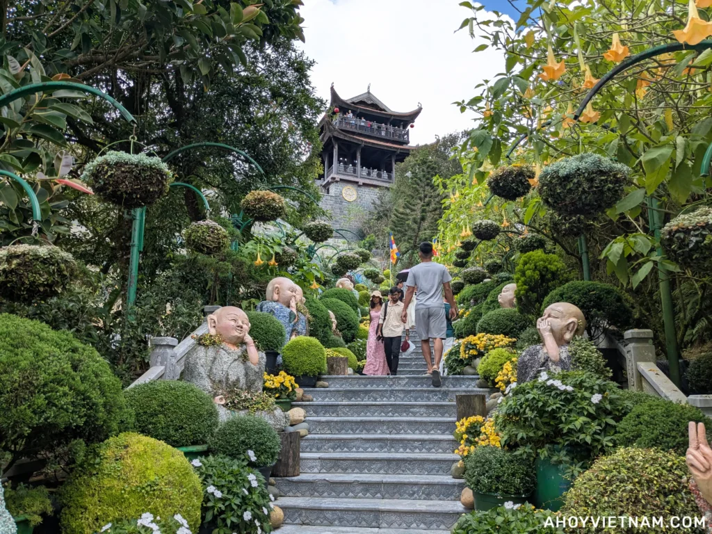 Climbing the stairs toward the Campanile (Lau Chuong) bell tower at Ba Na Hills in Da Nang