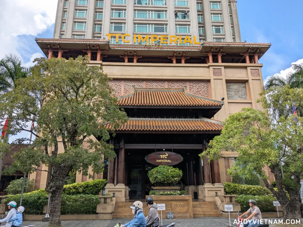 Scooters driving by the front of the TTC Imperial Hotel in Hue, Vietnam