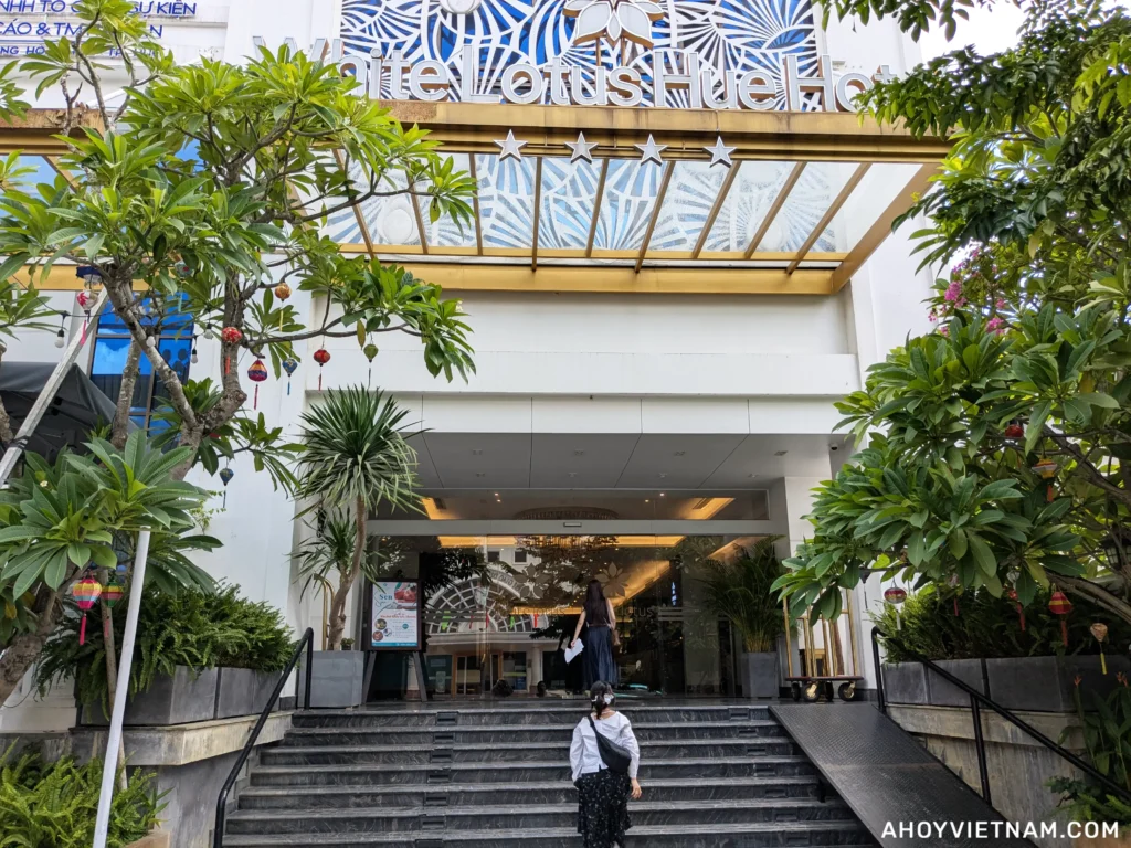 Guests walking into the White Lotus Hue Hotel in Hue, Vietnam