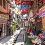 Standing on the tracks at Hanoi Train Street in Vietnam