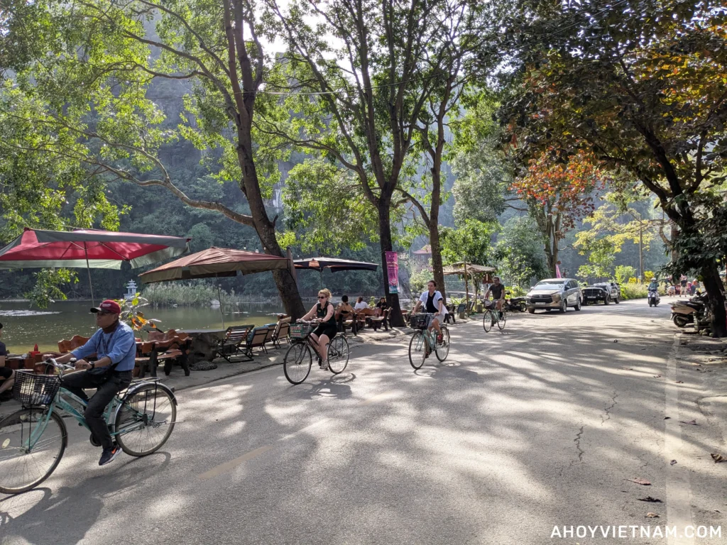 Tourists on bicycles near the Bich Dong Pagoda in Ninh Binh, Vietnam