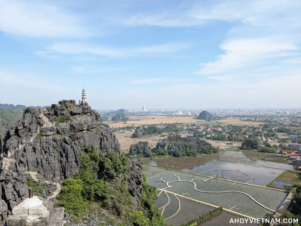 The stairs of the right path at Mua Cave in Ninh Binh, leading to the mountain's peak with a pagoda on top