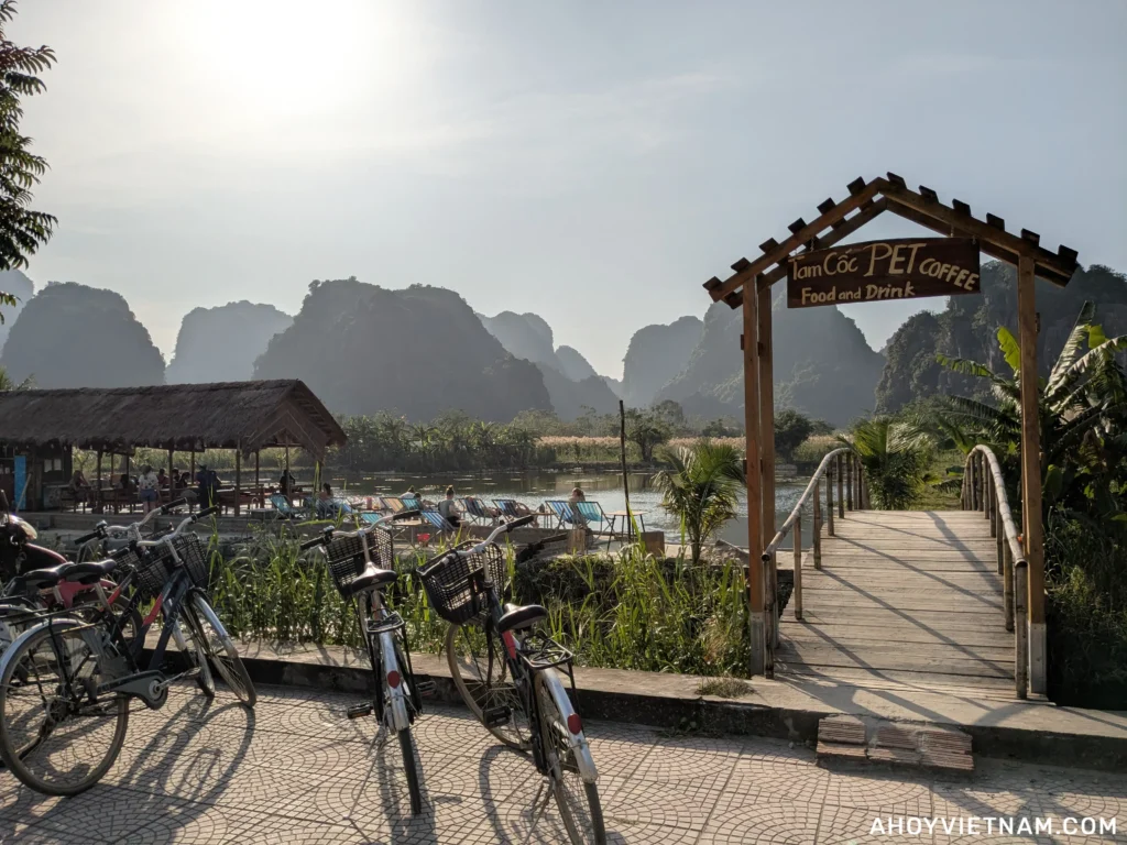 Tam Coc Pet Coffee in Ninh Binh, with a lake and limestone karsts in the distance
