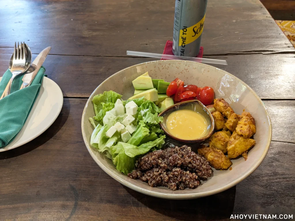 Eating a chicken bowl at Nom Bistro in Hoi An