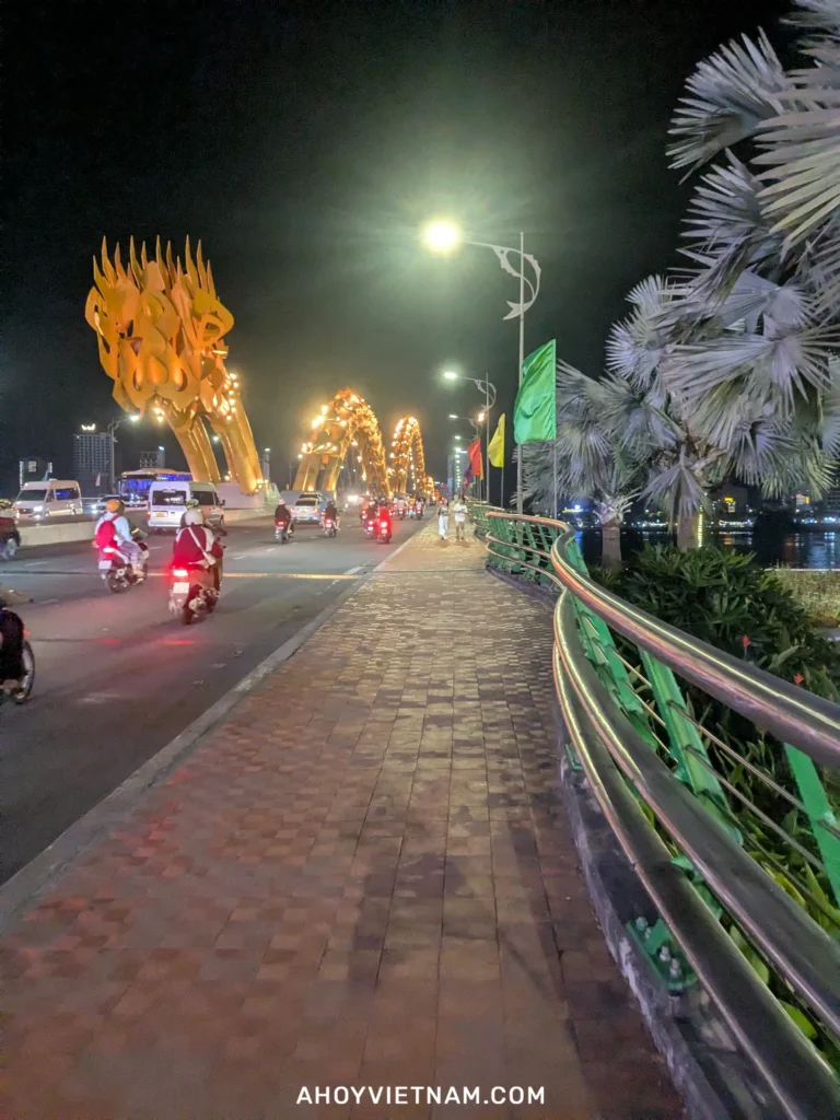 Walking by the tail of the Dragon Bridge in Da Nang at nighttime